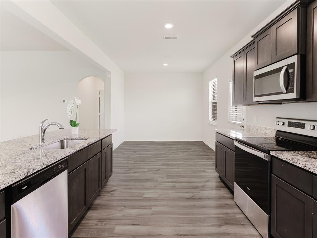 608 Aqueduct Drive Seagoville, TX 75159 - Photo 5 of 20 a large kitchen with stainless steel appliances granite countertop a sink stove and oven