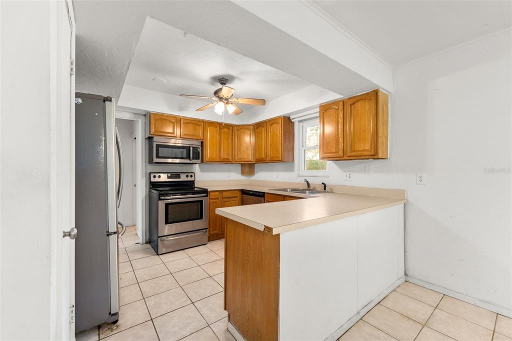 3116 West University Avenue Gainesville, FL 32607 - Photo 11 of 31 a kitchen with a sink appliances and cabinets