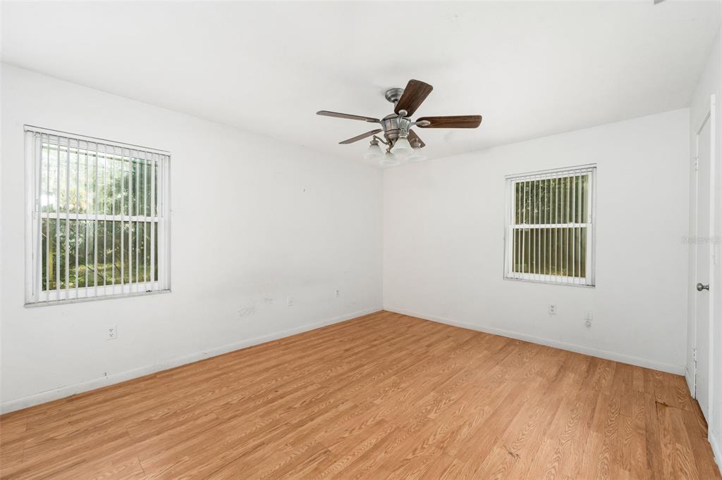 3116 West University Avenue Gainesville, FL 32607 - Photo 14 of 31 a view of empty room with wooden floor and fan