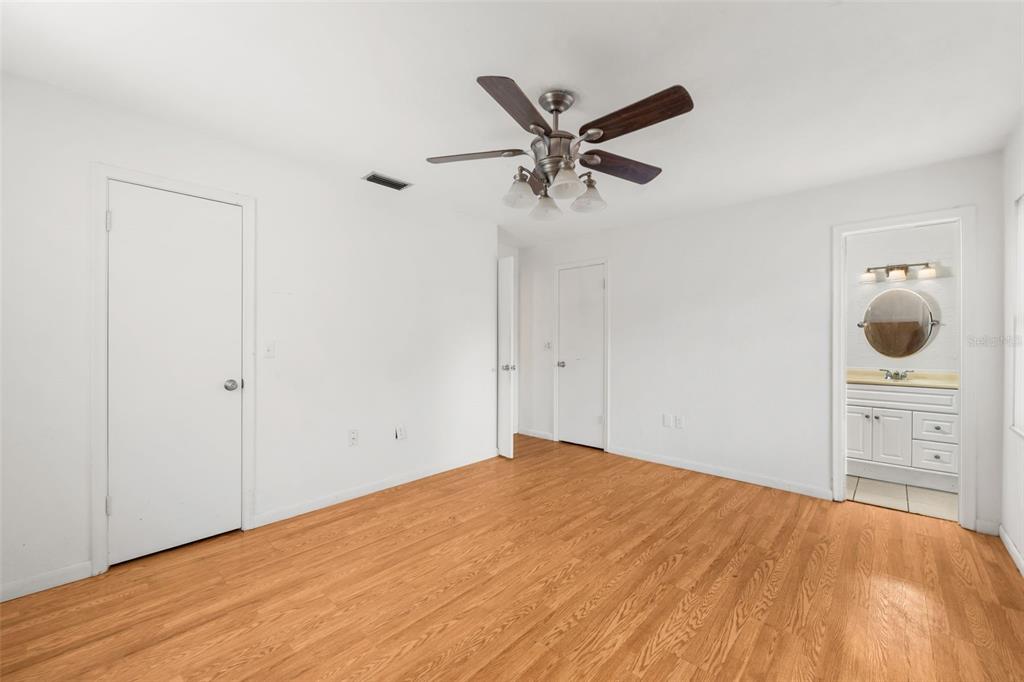 3116 West University Avenue Gainesville, FL 32607 - Photo 15 of 31 a bedroom with a bed and cabinets
