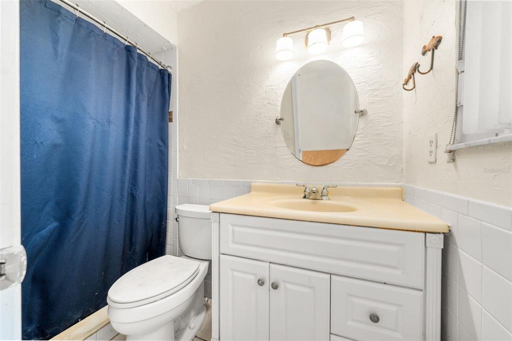 3116 West University Avenue Gainesville, FL 32607 - Photo 16 of 31 a bathroom with a sink a toilet and a mirror