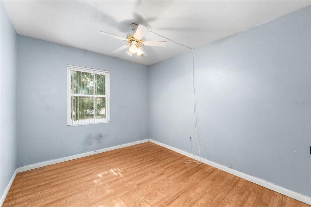 3116 West University Avenue Gainesville, FL 32607 - Photo 19 of 31 an empty room with a window and chandelier fan