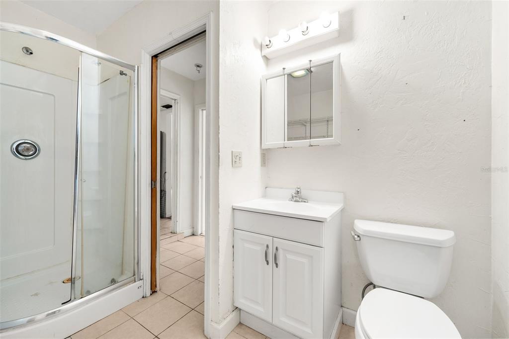 3116 West University Avenue Gainesville, FL 32607 - Photo 23 of 31 a bathroom with a toilet a sink and mirror