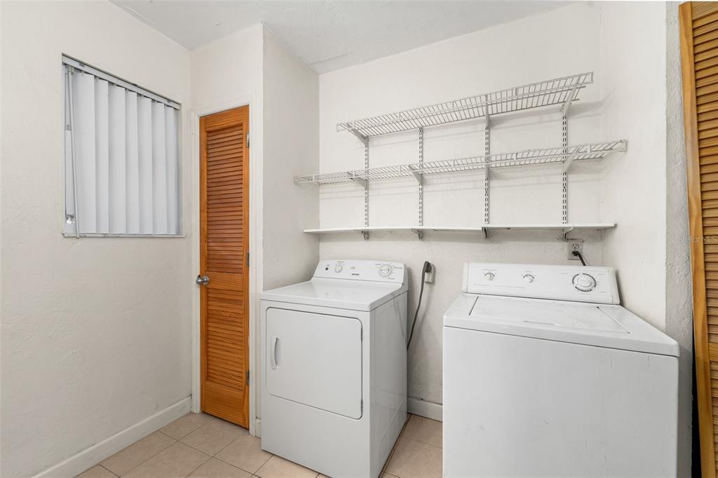3116 West University Avenue Gainesville, FL 32607 - Photo 24 of 31 a view of washer and dryer with kitchen in the background