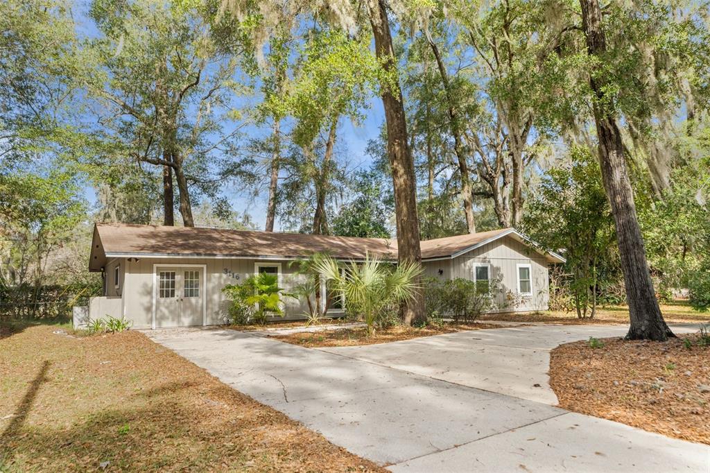 3116 West University Avenue Gainesville, FL 32607 - Photo 3 of 31 a front view of a house with a yard and potted plants