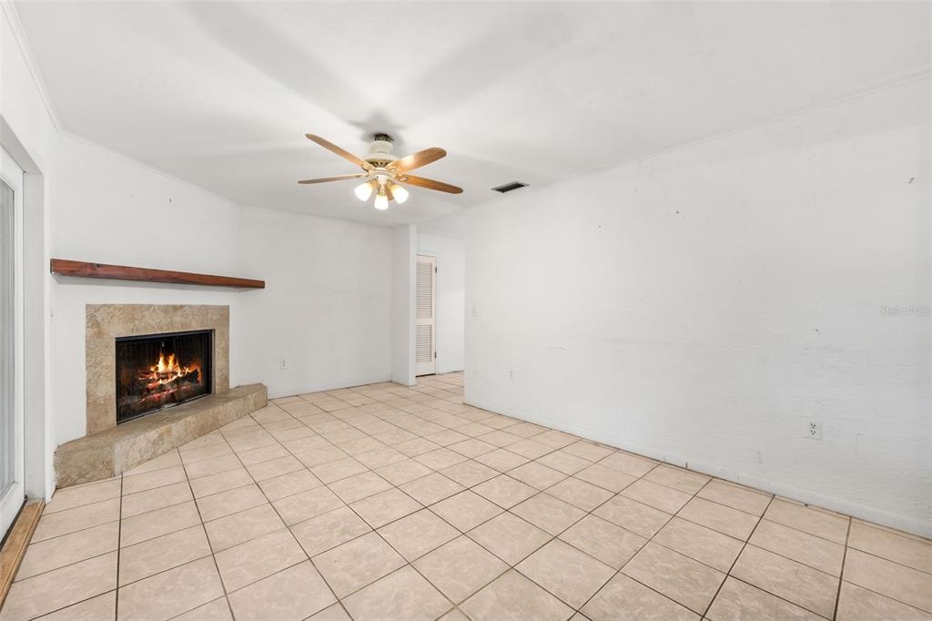 3116 West University Avenue Gainesville, FL 32607 - Photo 6 of 31 a view of an empty room with a fireplace