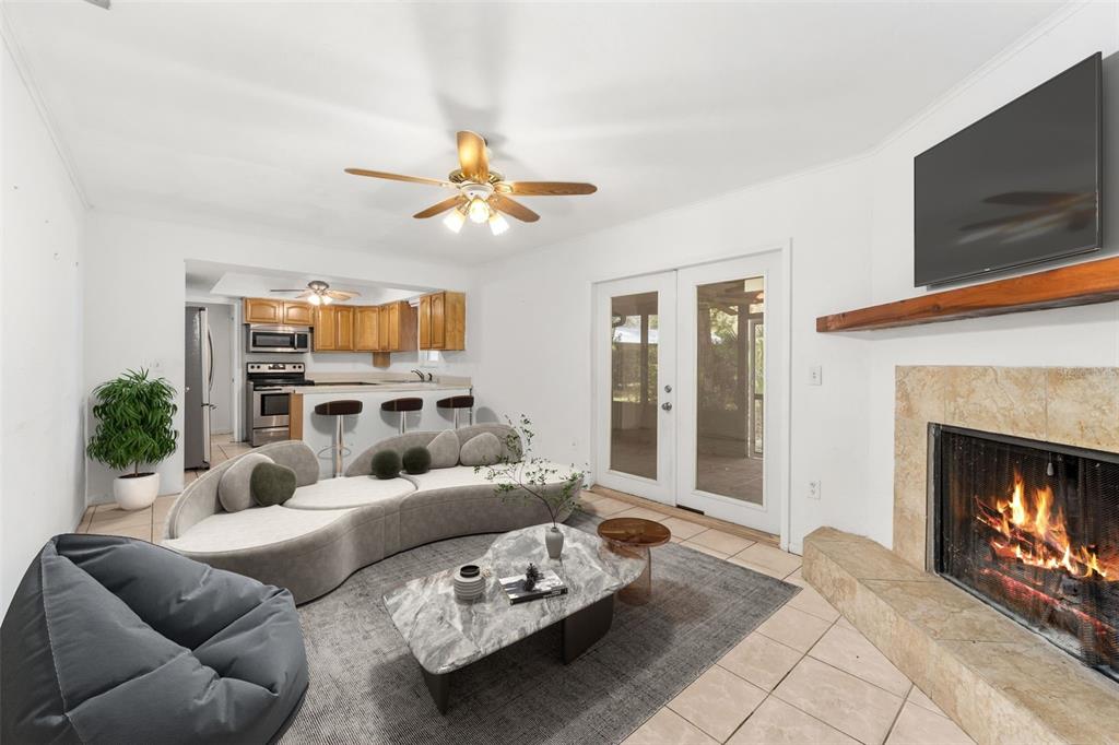 3116 West University Avenue Gainesville, FL 32607 - Photo 9 of 31 a living room with furniture a fireplace and a flat screen tv