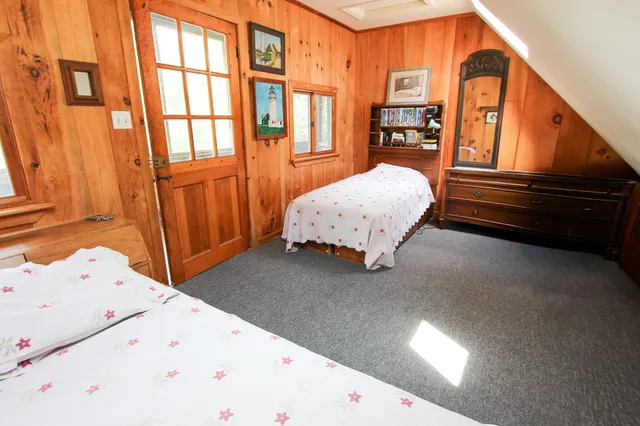 a living room with a bed furniture and windows