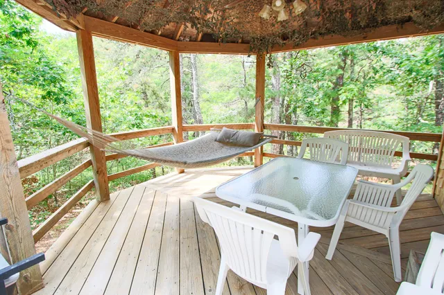 a view of a patio with table and chairs and wooden floor