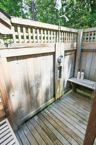 a view of a chair and table in the backyard