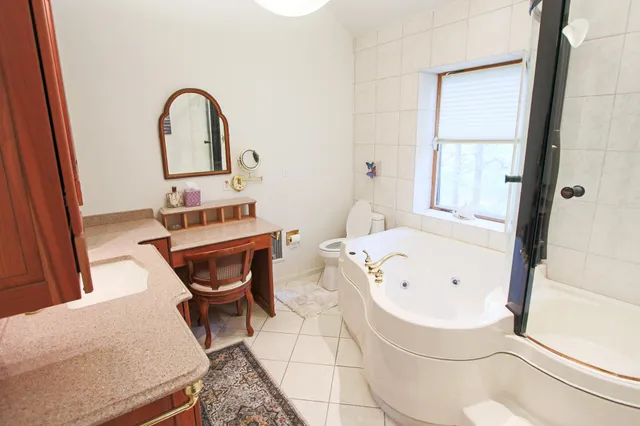 a bathroom with a bathtub sink and window