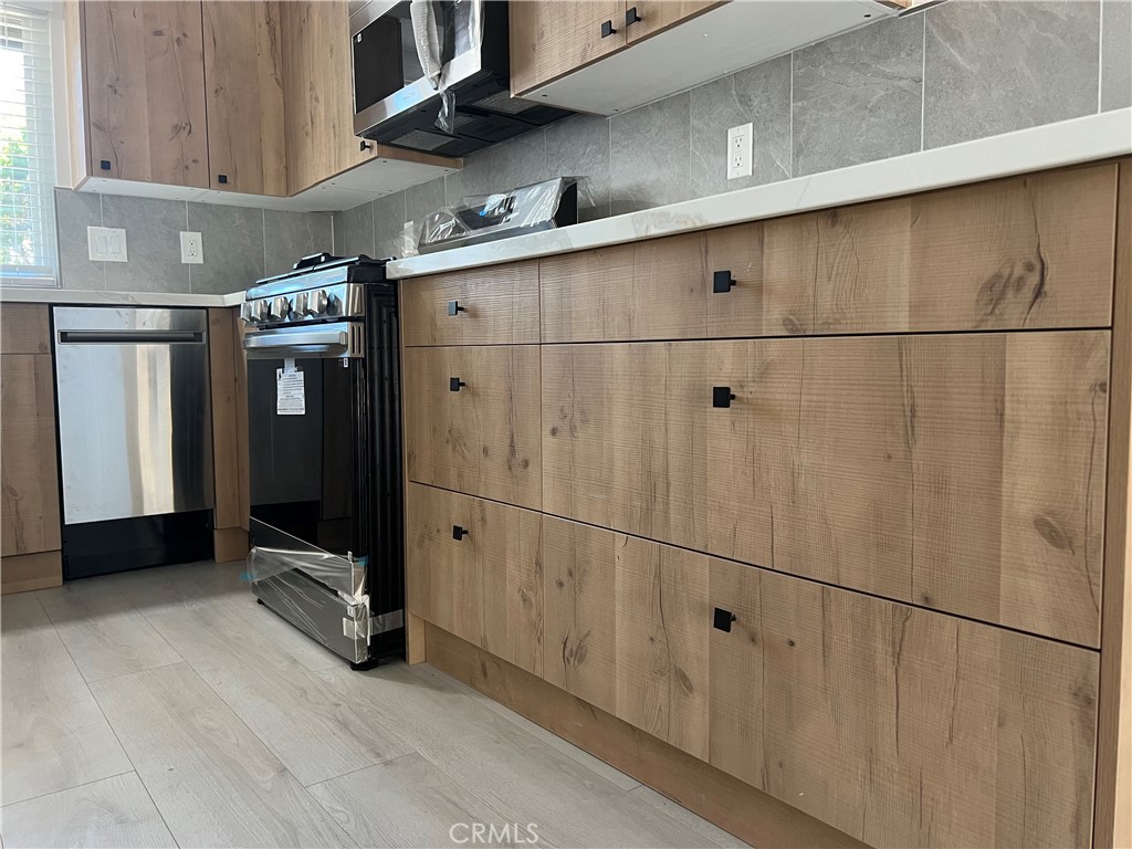 7561 Donna Avenue Reseda, CA 91335 - Photo 1 of 30 a kitchen with a refrigerator and a stove