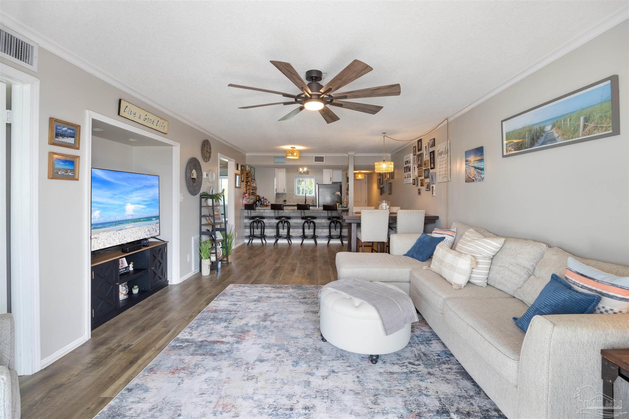 14100 River Road, Unit 122B Perdido Key, FL 32507 - Photo 4 of 46 a living room with furniture a dining table and kitchen view