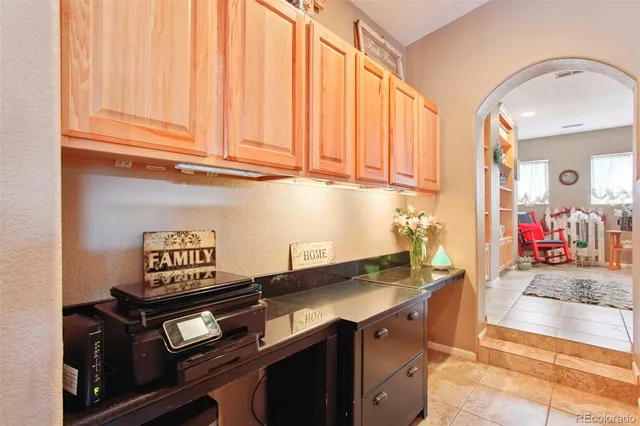 a kitchen with granite countertop a sink stove and cabinets