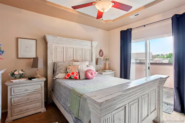 a bedroom with a bed a dresser and next to a window