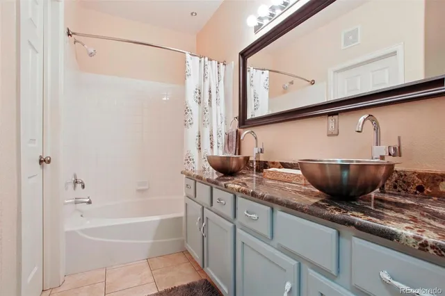 a bathroom with a granite countertop sink a toilet and bathtub