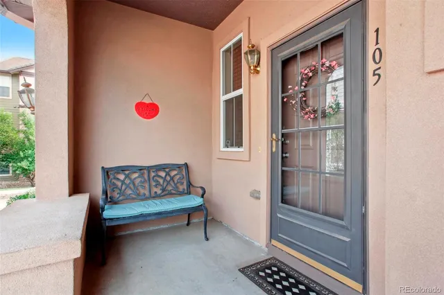 a view of a room that has a bench and a window in back