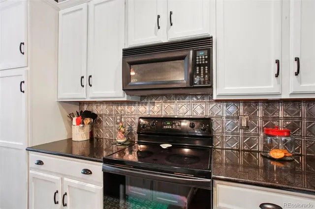 a kitchen with stainless steel appliances granite countertop a stove and cabinets