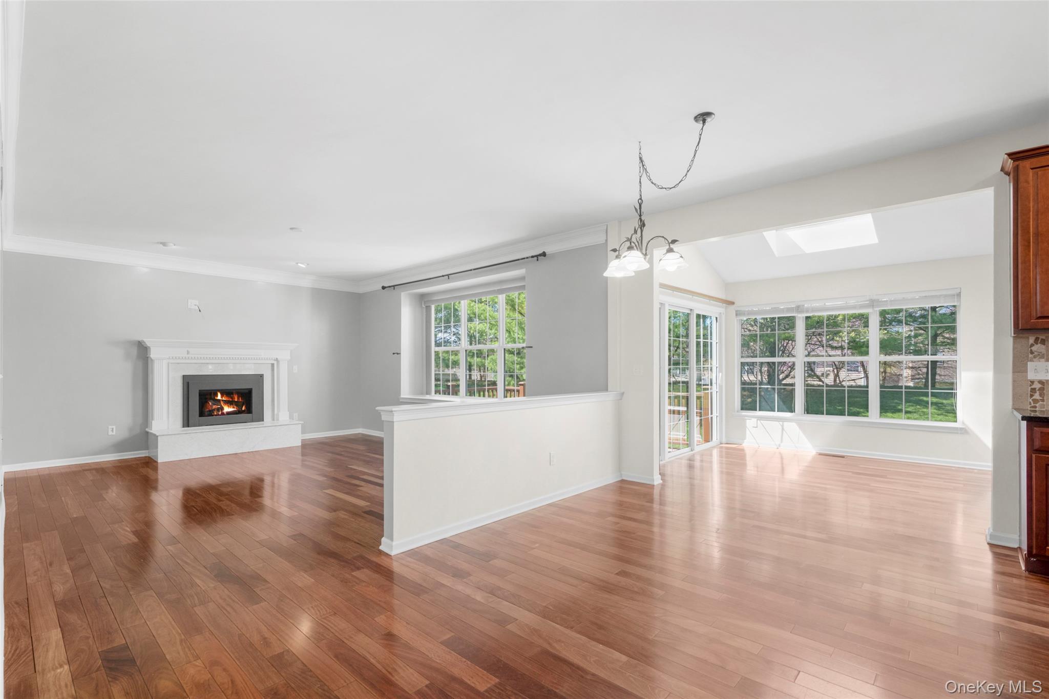 411 Vassar Place Fishkill, NY 12524 - Photo 12 of 39 a view of an empty room with wooden floor and a window