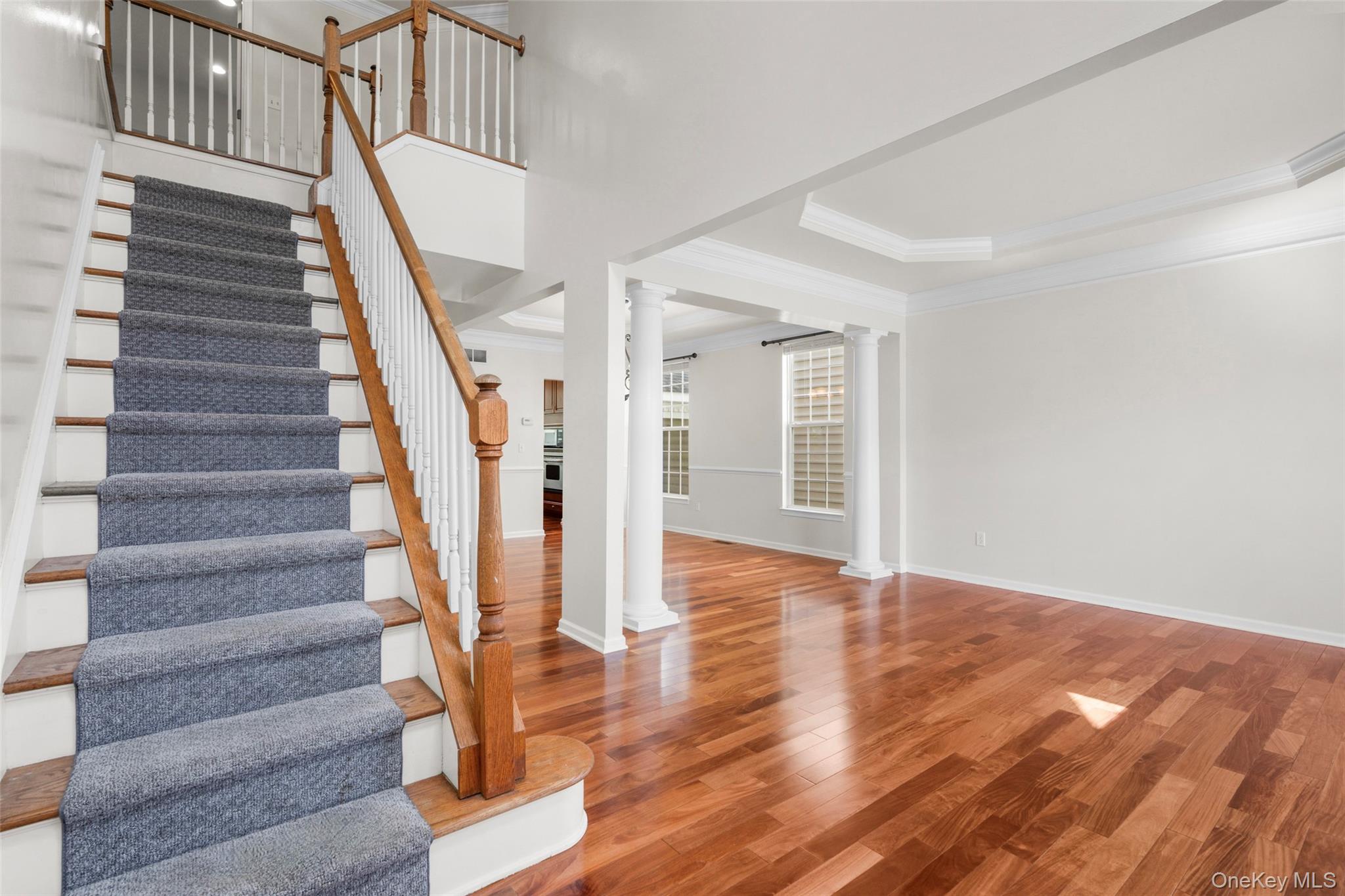 411 Vassar Place Fishkill, NY 12524 - Photo 20 of 39 a view of staircase with wooden floor and white walls