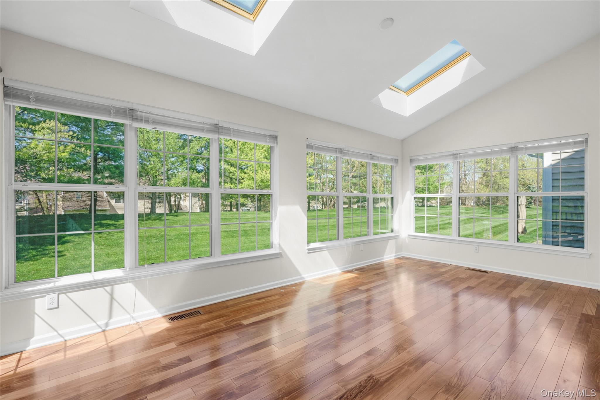 411 Vassar Place Fishkill, NY 12524 - Photo 8 of 39 a view of an empty room with wooden floor and a window