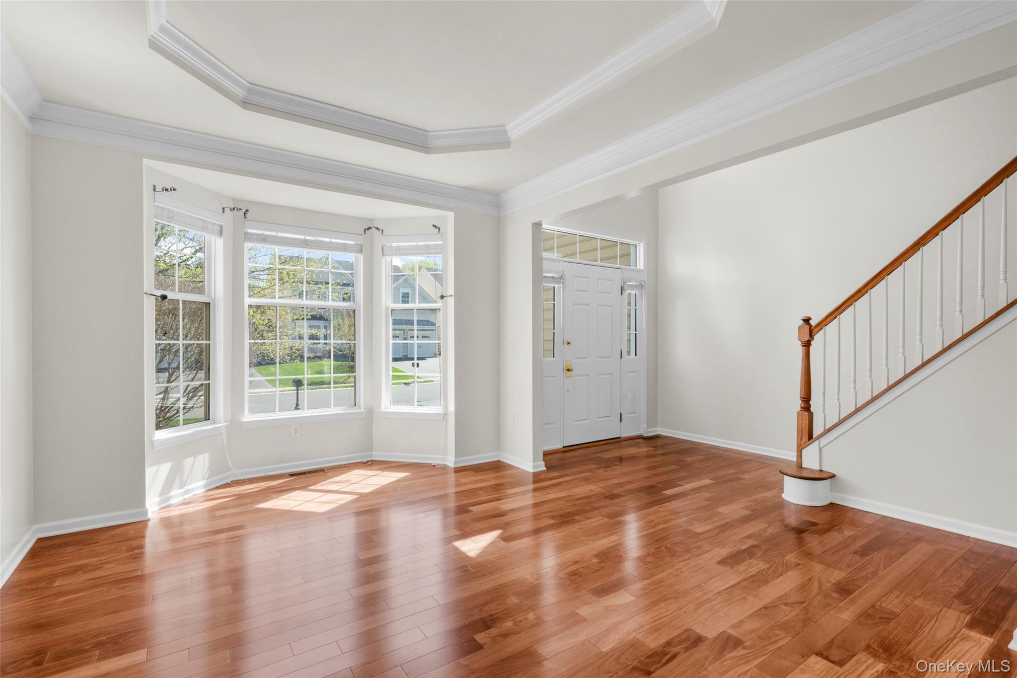 411 Vassar Place Fishkill, NY 12524 - Photo 10 of 39 a view of an empty room with wooden floor and a window