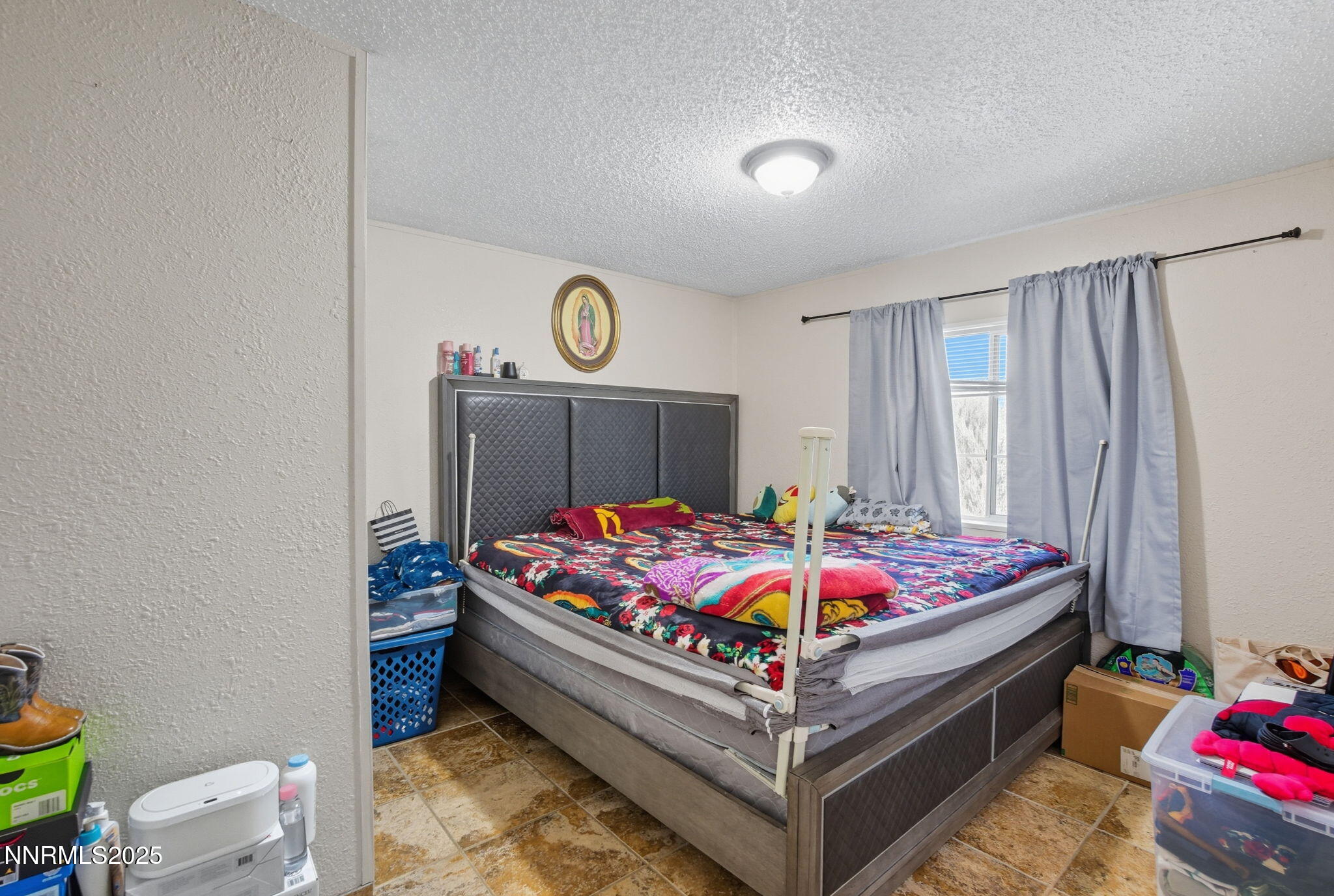 2135 Barberry Way Reno, NV 89512 - Photo 13 of 16 a bed room with a bed and a table