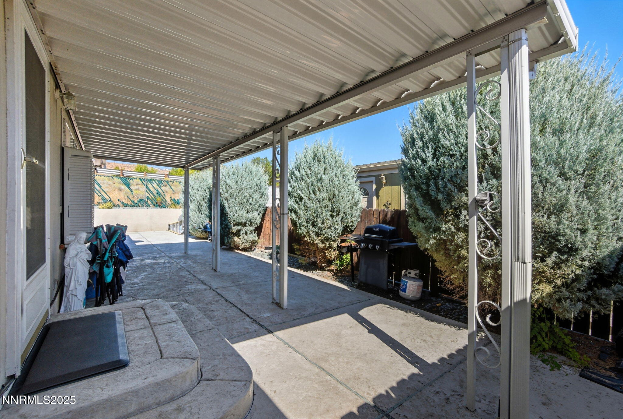 2135 Barberry Way Reno, NV 89512 - Photo 16 of 16 a view of a patio with table and chairs potted plants with wooden floor and floor to ceiling window