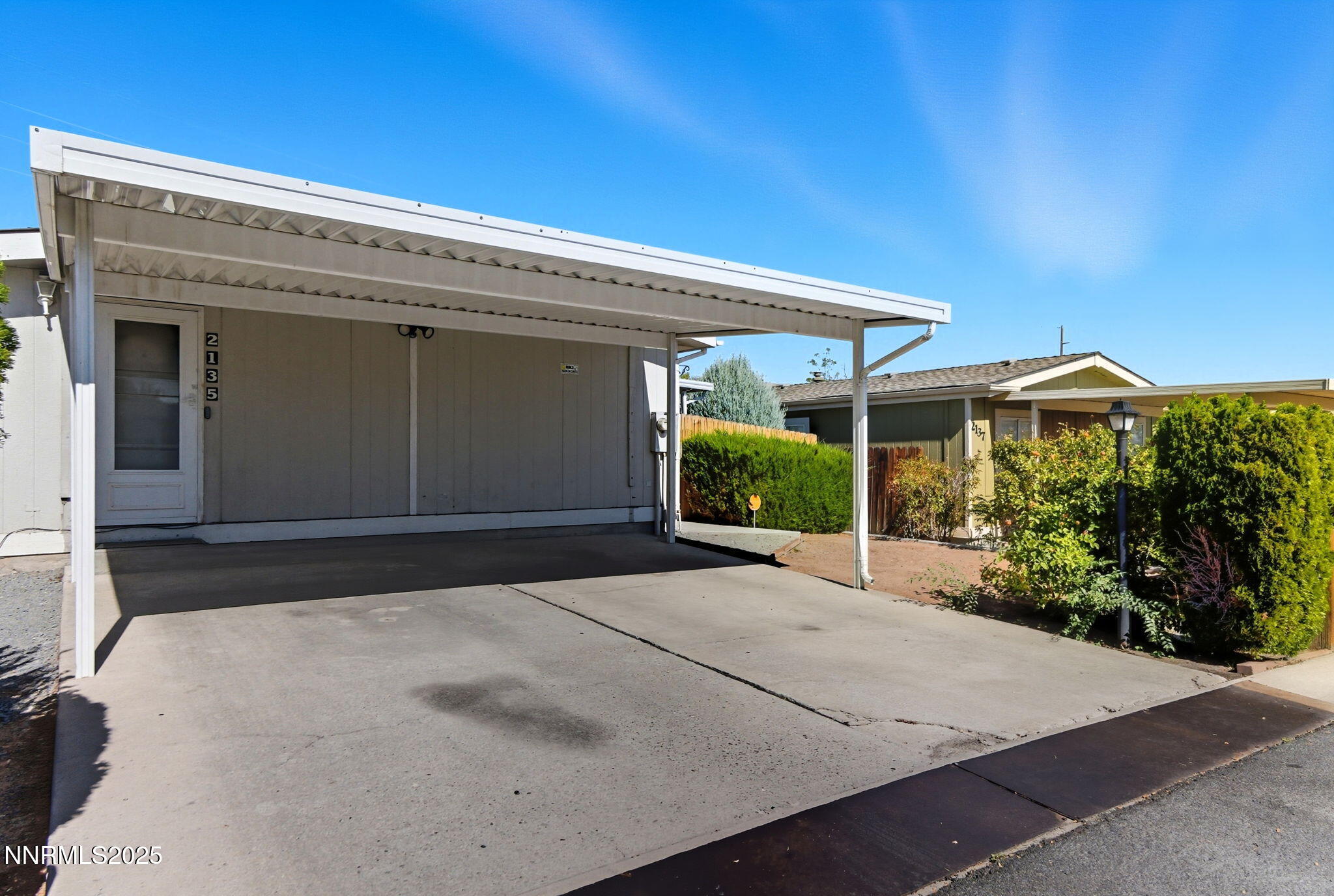 2135 Barberry Way Reno, NV 89512 - Photo 3 of 16 a front view of a house with a yard and garage