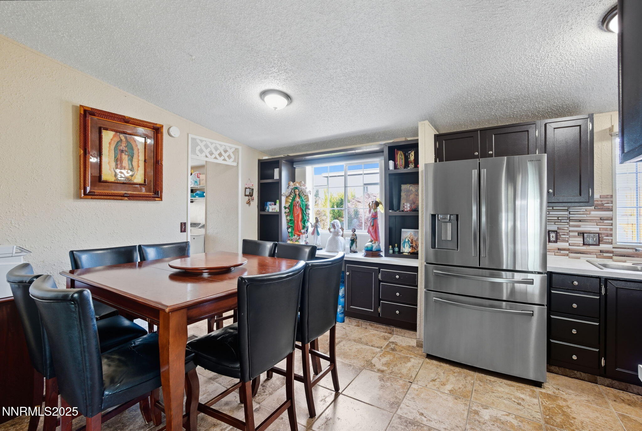 2135 Barberry Way Reno, NV 89512 - Photo 6 of 16 a kitchen with stainless steel appliances granite countertop a refrigerator and a stove top oven