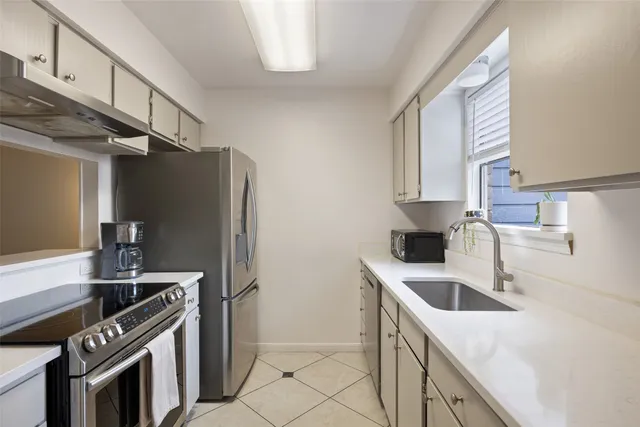 a kitchen with a sink stove and refrigerator