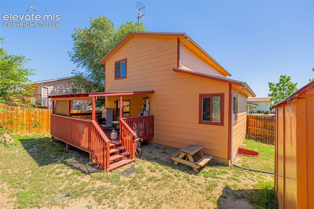 613 Wheat Field Road Fountain, CO 80817 - Photo 19 of 32 a view of a backyard with a deck