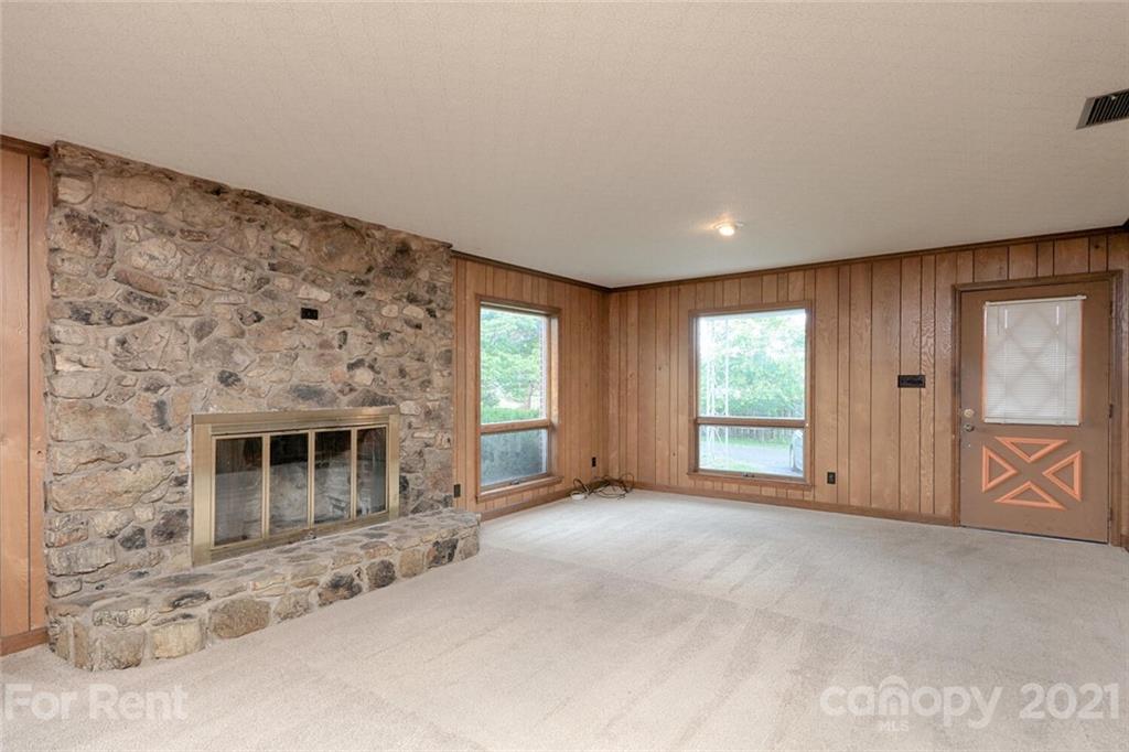 190 Turbyfill Road Mooresville, NC 28117 - Photo 4 of 28 a view of an empty room with a fireplace and a window