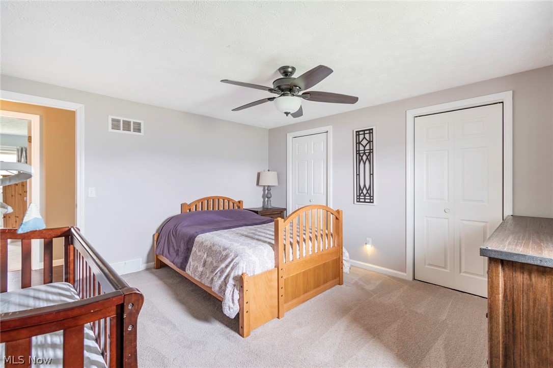 8370 Herbert Road Canfield, OH 44406 - Photo 27 of 48 Bedroom with light colored carpet and ceiling fan