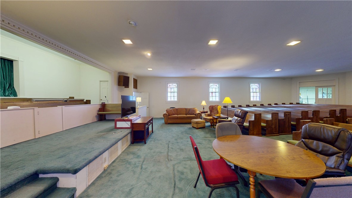 415 Church Street Pendleton, SC 29670 - Photo 12 of 35 A spacious common area with elevated platforms, multiple windows, and comfortable seating, offering versatile usage.