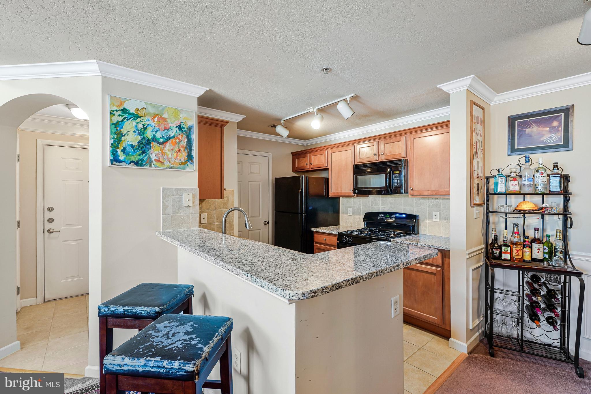 503 Sunset View Terrace Southeast, Unit 407 Leesburg, VA 20175 - Photo 12 of 35 a kitchen with stainless steel appliances granite countertop a stove and a sink