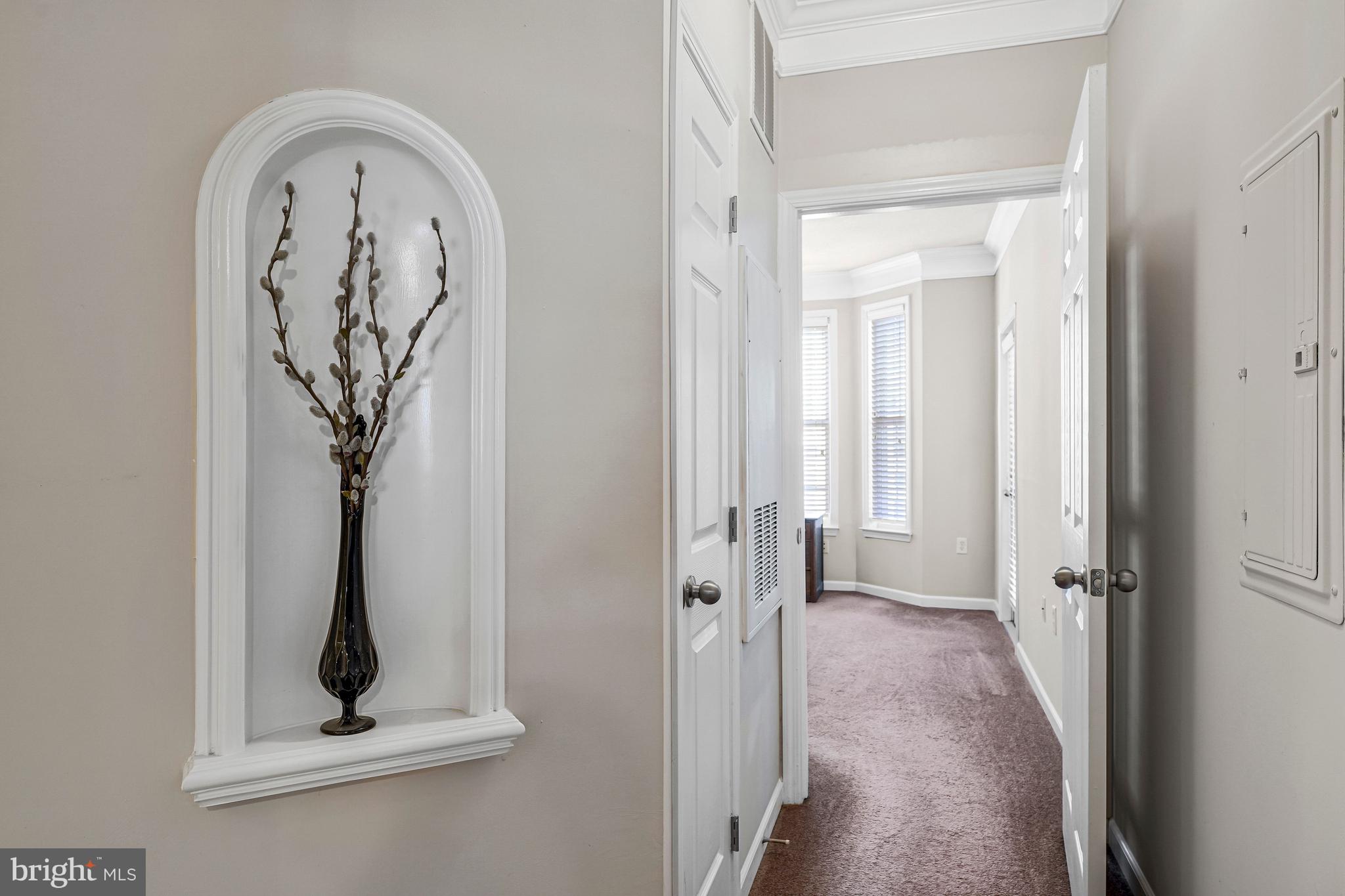 503 Sunset View Terrace Southeast, Unit 407 Leesburg, VA 20175 - Photo 17 of 35 a view of a hallway with wooden floor and a potted plant