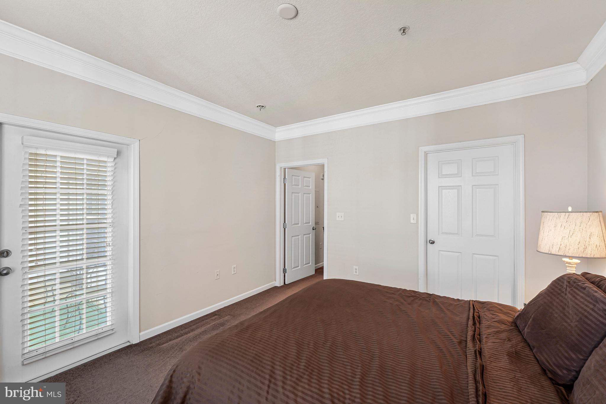503 Sunset View Terrace Southeast, Unit 407 Leesburg, VA 20175 - Photo 22 of 35 a bedroom with a bed and a window