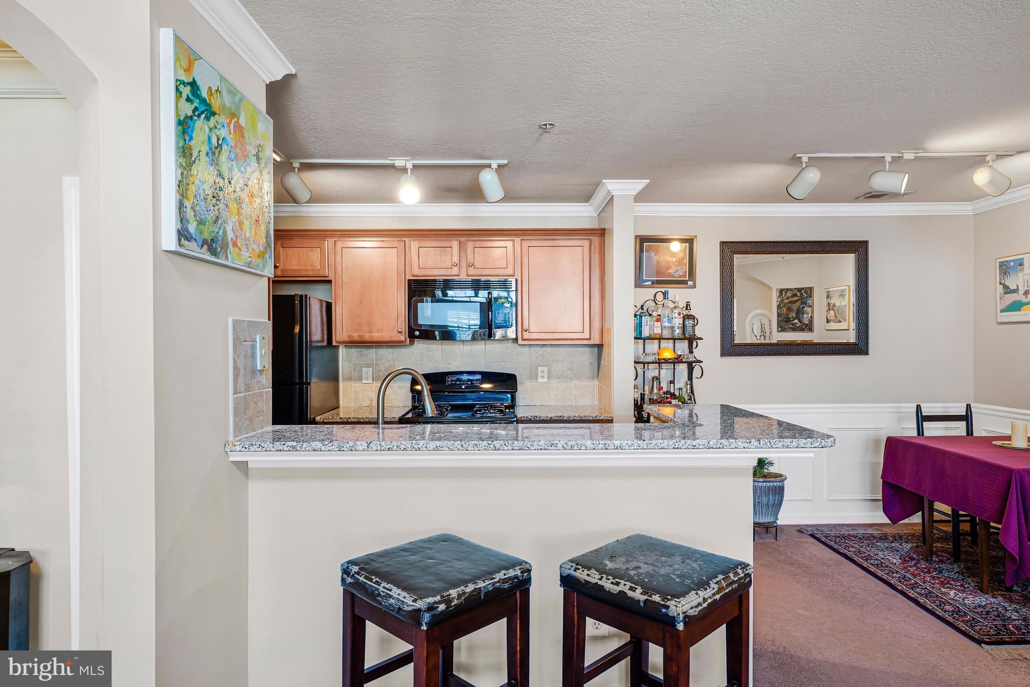 503 Sunset View Terrace Southeast, Unit 407 Leesburg, VA 20175 - Photo 9 of 35 a bathroom with a granite countertop sink a mirror and a bathtub
