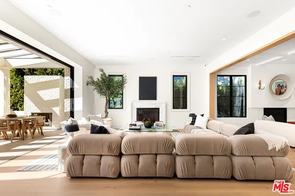 a bedroom with a large bed and a large window with balcony view