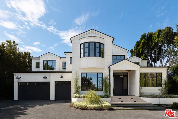 a front view of a house with a fireplace and garage