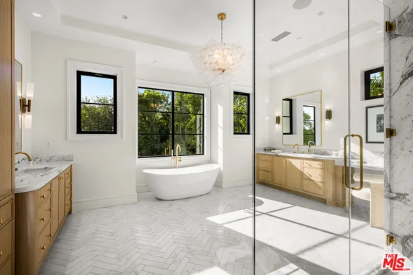 a large spacious bathroom with a granite countertop tub and a large window