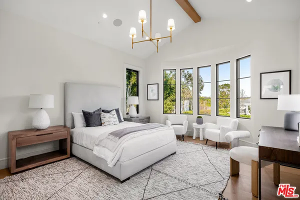 a bedroom with a large bed and a couch