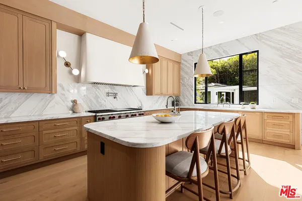 a kitchen with a table chairs and a wooden floor