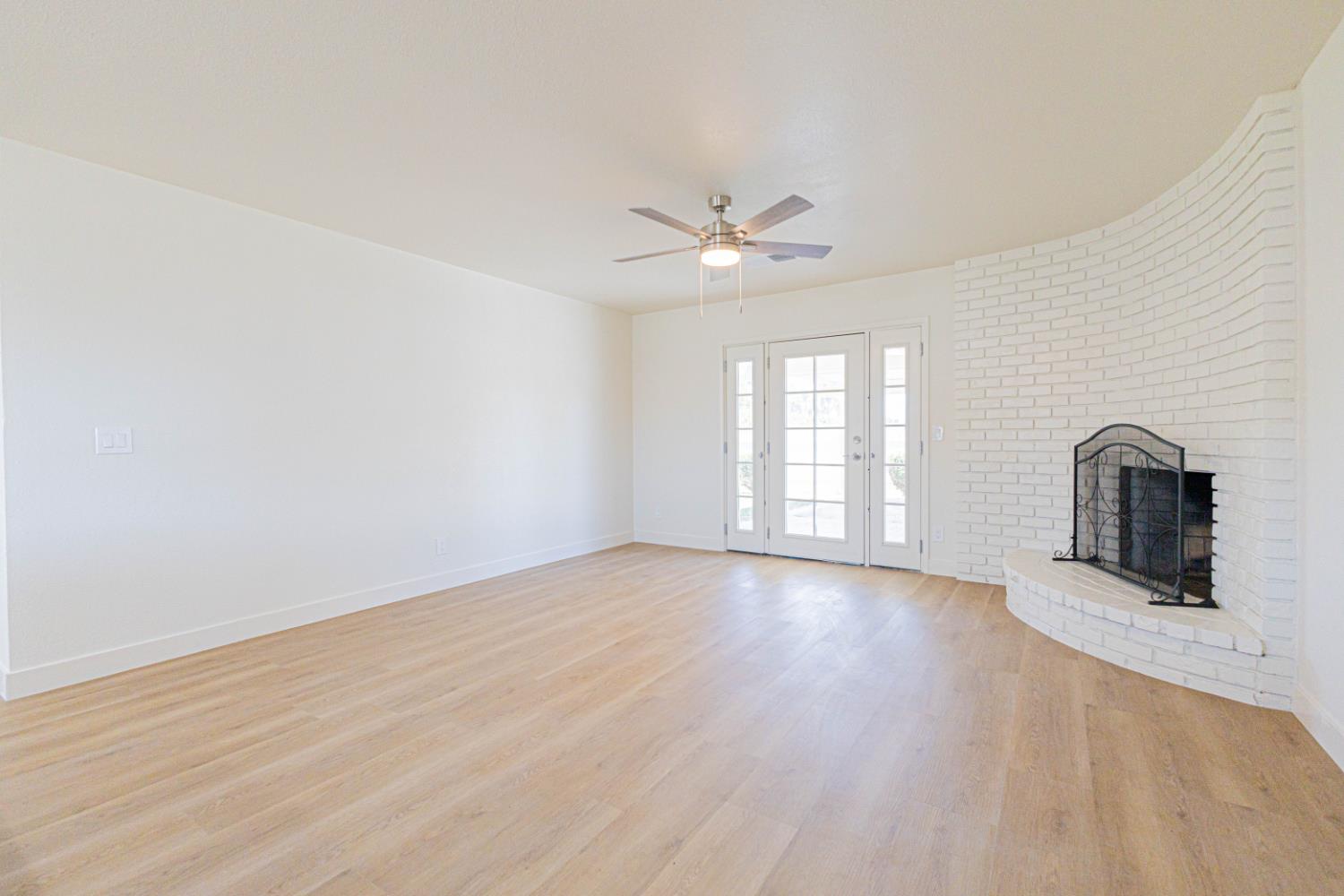 17925 Rodeo Drive Madera, CA 93638 - Photo 4 of 26 an empty room with chandelier fan and windows