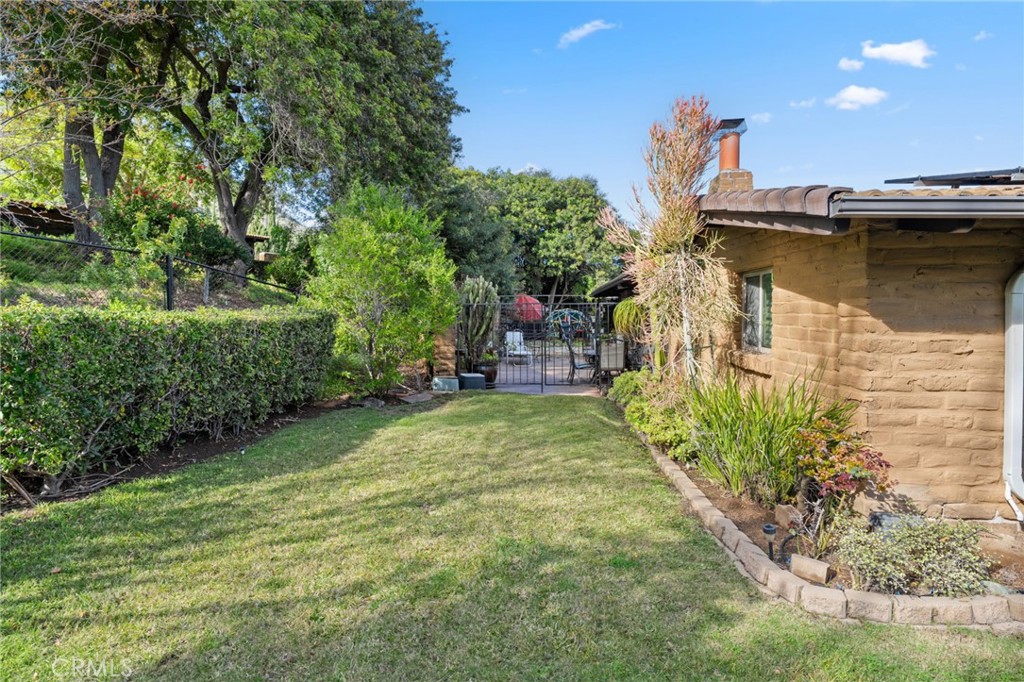 4706 Vía Tala Fallbrook, CA 92028 - Photo 35 of 73 Looking towards the fenced rear patio from the back grass yard which is also fenced