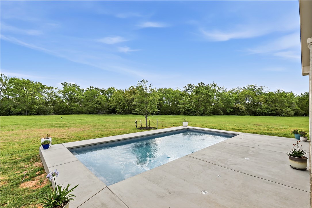 10701 Harvey Ranch Road College Station, TX 77845 - Photo 39 of 48 a view of swimming pool with seating area and trees in the background