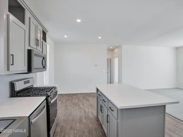 a kitchen with cabinets a sink and a window