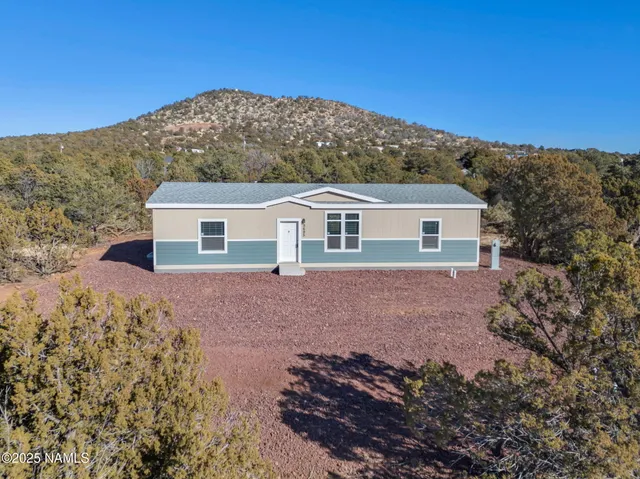 a view of house with a yard