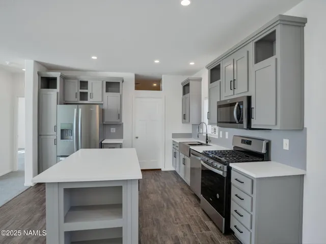 a kitchen with stainless steel appliances a refrigerator stove and sink